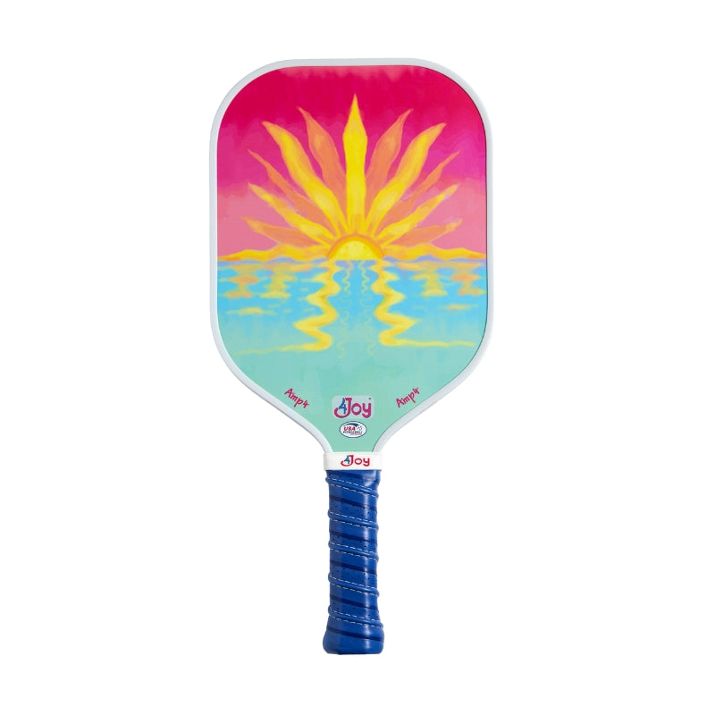 The 4Joy Paddles pickleball paddle features a vibrant yellow sun over blue water with a pink and orange sky, a blue wrapped handle, and "Joy" printed on it. Its honeycomb core adds durability and performance.